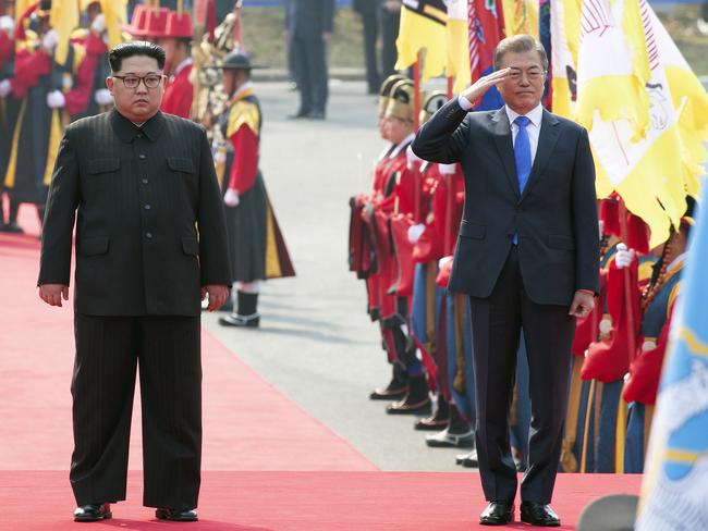 Mr Moon salutes as Kim stands during a welcome ceremony at the border village of Panmunjom. Picture: Korea Summit Press Pool/AP