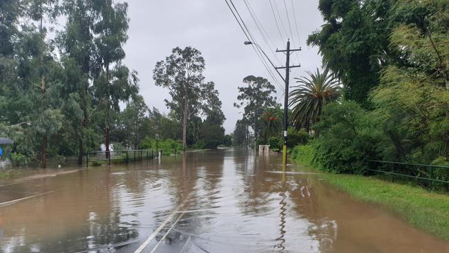 Water over River Road, Emu Plains, at 11am on March 21. Picture: Joel Erickson