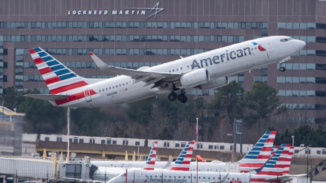 (FILES) In this file photo taken on March 11, 2019 A Boeing 737 flown by American Airlines passes by the Lockheed Martin building as it takes off from Ronald Reagan Washington National Airport in Arlington, Virginia. - US President Donald Trump on March 13, 2019, announced a plan to ground all Boeing 737 MAX aircraft amid intense international and political pressure following the second deadly crash in less than five months. "We're going to be issuing an emergency order of prohibition regarding all flights of the 737 MAX 8 and 737 MAX 9," Trump told reporters the White House. (Photo by Andrew CABALLERO-REYNOLDS / AFP)