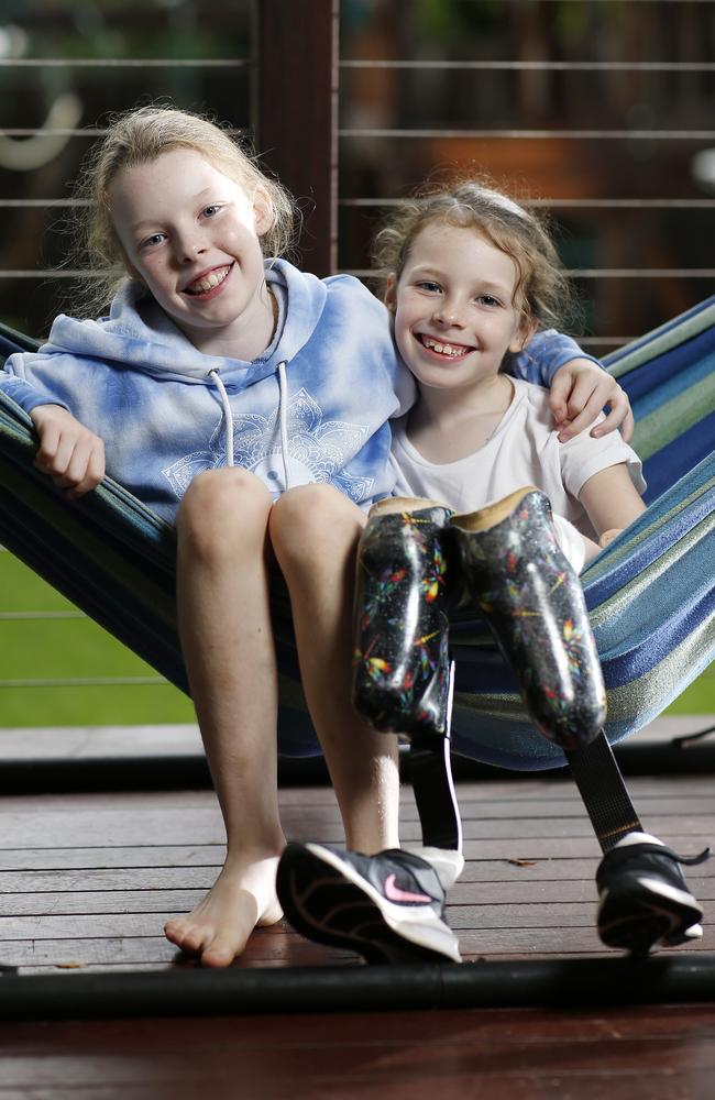 Ellie Wilkinson, 9, and her sister Mia Wilkinson, 8, who lost part of all four limbs after developing sepsis more than three years ago. Picture: Josh Woning