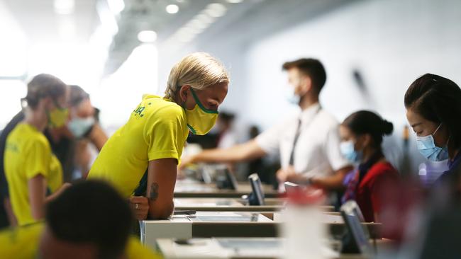 The first wave of athletes and officials from the Australian Olympic athletics team, who have been training at Barlow Park in Cairns for the past two weeks, departed for Tokyo on Sunday morning. Pole vaulter Liz Parnova checks in for her flight at the Cairns Airport. Picture: Brendan Radke