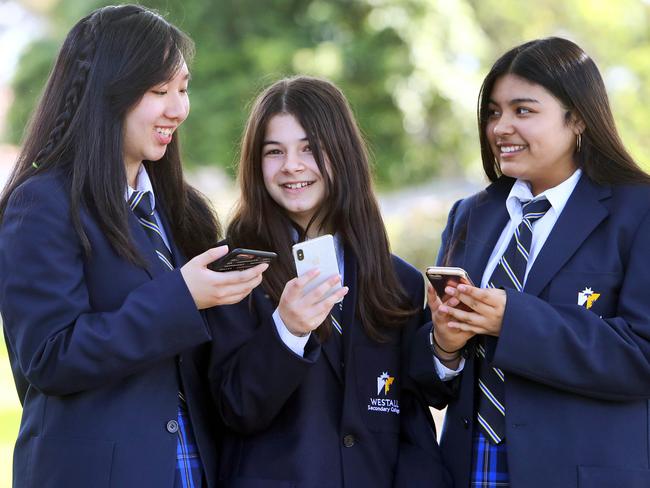 04/09/19 Westall secondary college students (L-R) Monineath Seang (14), Zoi Spiliopoulou (13) and Malaya Dudek (12) who are going to a Melbourne Writers Festival story-telling project 'Not Your Face' which focuses on selfie-led social media culture is playing an increasingly pervasive role in shaping the relationships young women have with their appearance and self worth.. Aaron Francis/The Australian