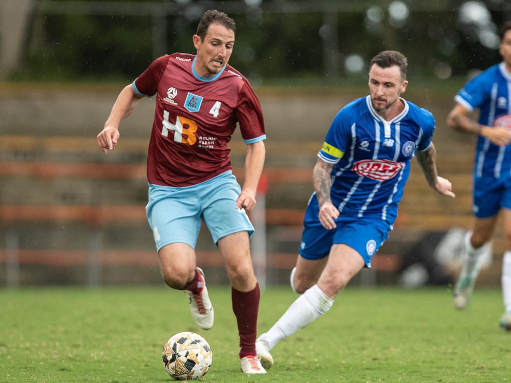 Josh Symons in control of the ball against Olympic captain Roy O Donovan. Picture: Julian Andrews