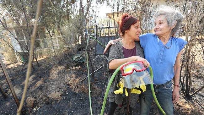 Wytaliba resident Lynn Hetherington with friend Karen Hare (R) successfully fought to save her house with a during a fierce bush fire claimed the lives of 2 people in the area. Picture: Lyndon Mechielsen