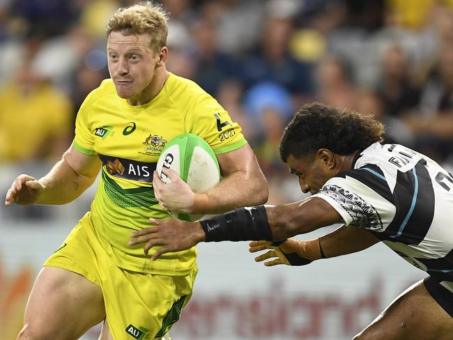 Lachlan Miller of Australia runs the ball during the Oceania Sevens Challenge match between Fiji and Australia at Queensland Country Bank Stadium. (Photo by Ian Hitchcock/Getty Images)