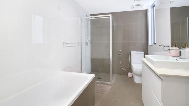 The modern bathroom features a shower and a tub.