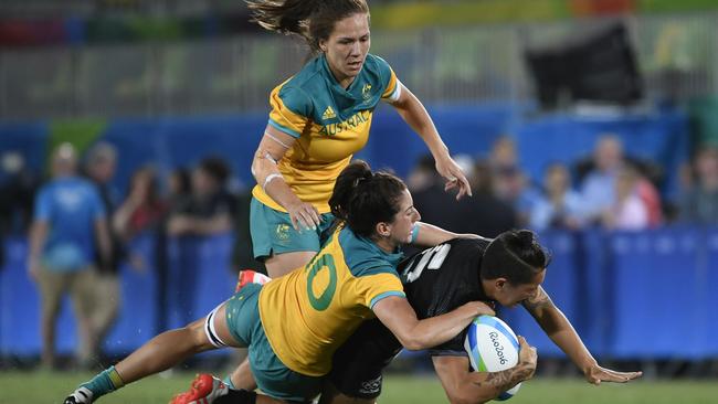 Australia's Alicia Quirk tackles New Zealand's Gayle Broughton in the women’s rugby sevens gold medal match. Picture: John MacDougall