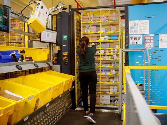 Workers can then pick the items from the shelves driven around by robots. Picture: NewsWire / Nikki Short