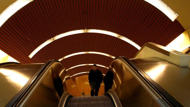 A man takes the escalators at Flagstaff Station.