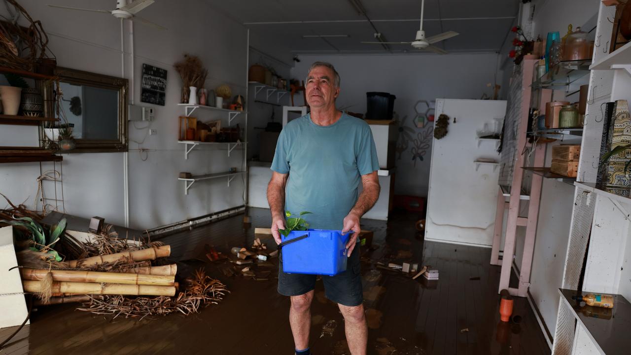 Taree resident Peter Lay begins the clean-up effort at his home. Picture: NewsWire / Scott Calvin