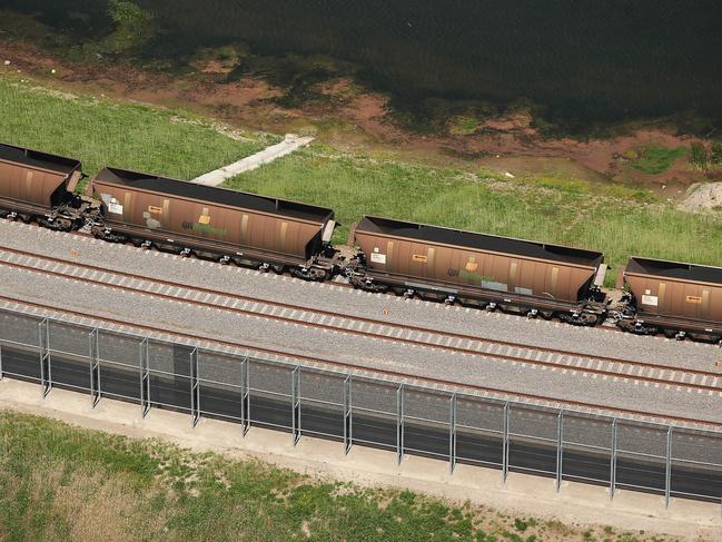 A shipment of coal arrives in a freight train bearing the branding of QR National, the former name of Aurizon Holdings Ltd., at the Newcastle Coal Terminal in this aerial photograph taken in Newcastle, Australia, on Saturday, Oct. 3, 2015. The slowdown across global economies is exacerbating a coal glut that's driven prices for the fuel to the lowest level in eight years, according to Glencore Plc. Photographer: Brendon Thorne/Bloomberg via Getty Images