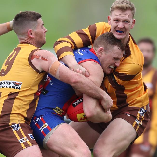 Beechworth’s Tristan Stead is gang tackled by Kiewa-Sandy Creek pair Josh Hicks, left, and Tristan Mann.