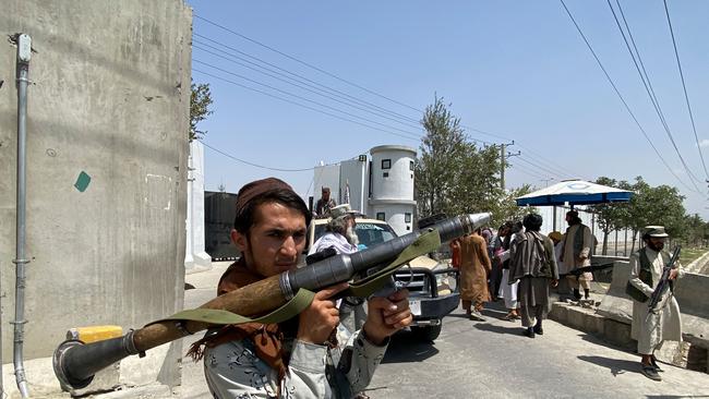 A Taliban fighter stands guard with others at an entrance gate outside the Interior Ministry in Kabul. Picture: AFP