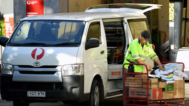 An Australia Post worker unloads packages at Surry Hills. Picture: NCA NewsWire/Joel Carrett