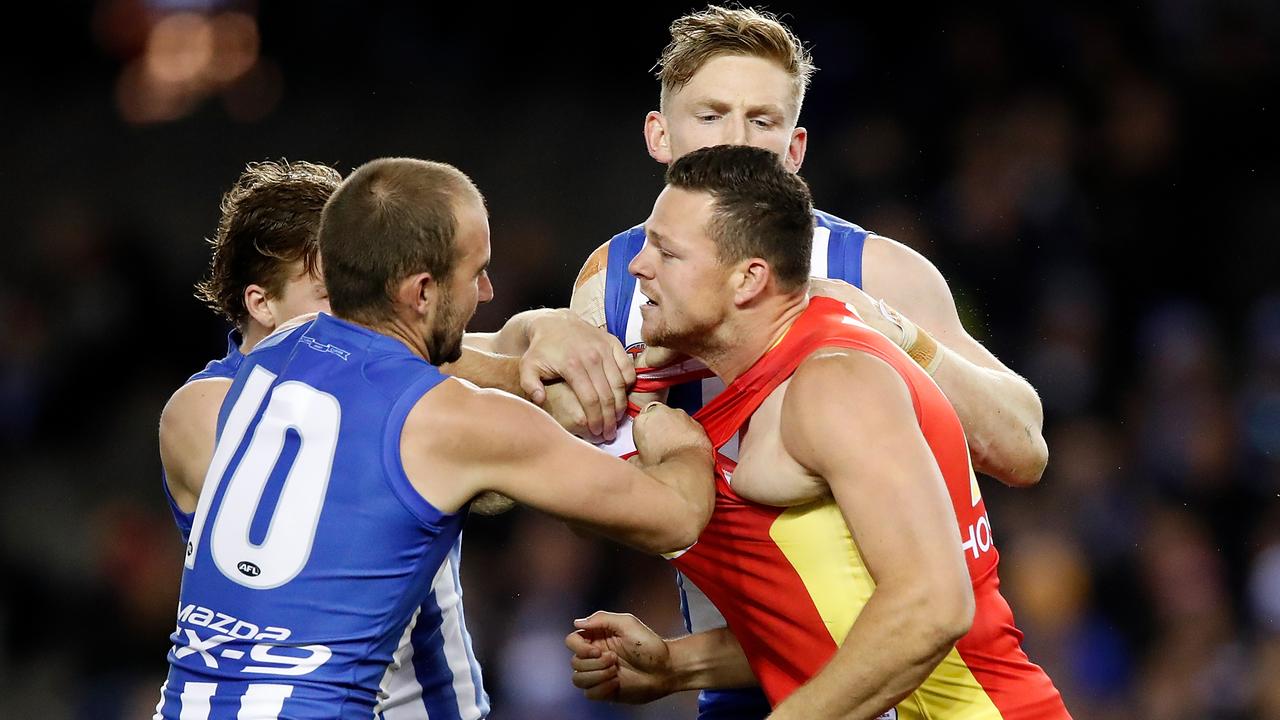 Ben Cunnington (left) and Jack Ziebell of the Kangaroos remonstrate with Steven May of the Suns after a hit from May on Shaun Higgins. (Photo by Adam Trafford/AFL Media/Getty Images)