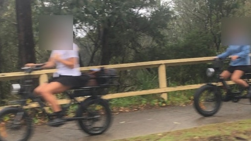 Two girls on e-bikes on the shared pedestrian path on Pittwater Rd, Manly. Picture: Jim O’Rourke