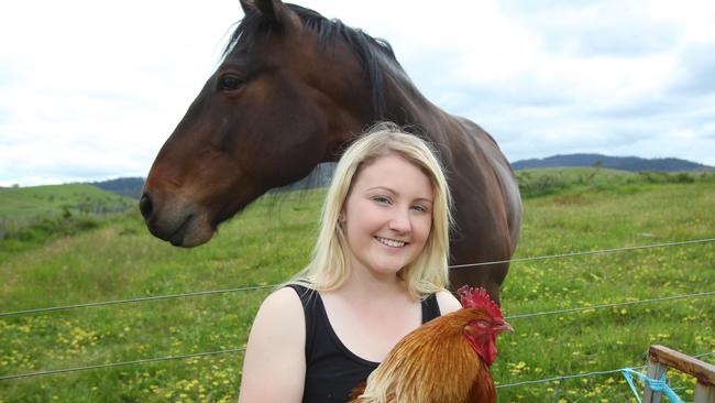 Grace Hills with some of the animals she has rescued, Henry the rooster and Harley the horse, at her Hayes property in the Derwent Valley. Picture: MATT THOMPSON.