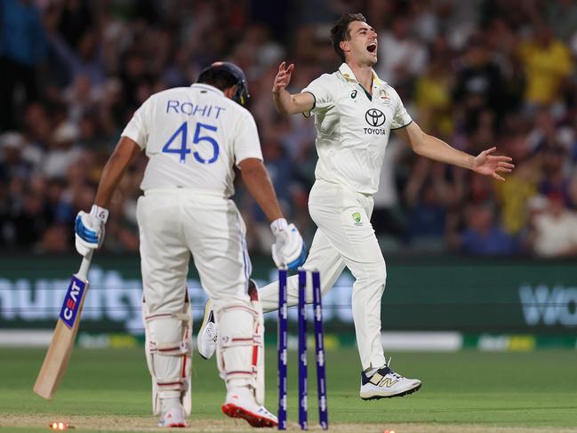 Pat Cummins knocks over Rohit Sharma late on Saturday night. Picture: Paul Kane/Getty Images