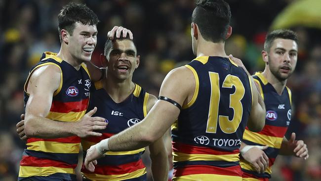 Mitch McGovern celebrates his goal with Charlie Cameron and Taylor Walker. Picture: SARAH REED