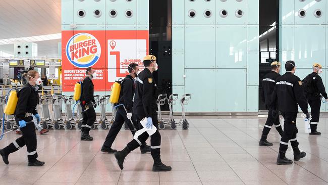 Members of the Military Emergencies Unit prepare to carry out a general disinfection at Josep Tarradellas Barcelona-El Prat airport in El Prat de Llobregat. Picture: AFP