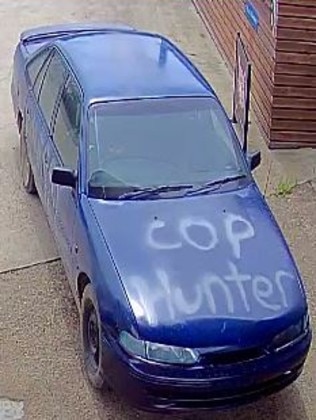 The distinctive blue car with the words “Cop Hunter” written on the hood.