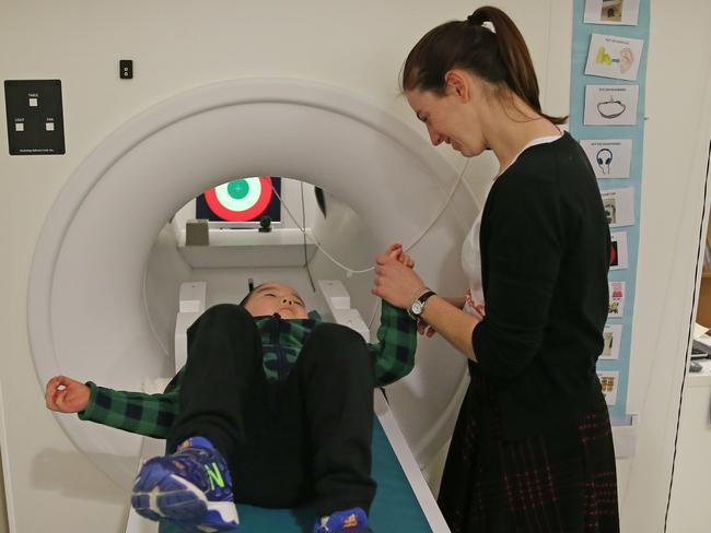 Charles gets his turn in a mock MRI machine with the help of Ms DeMayo. Picture: Toby Zerna