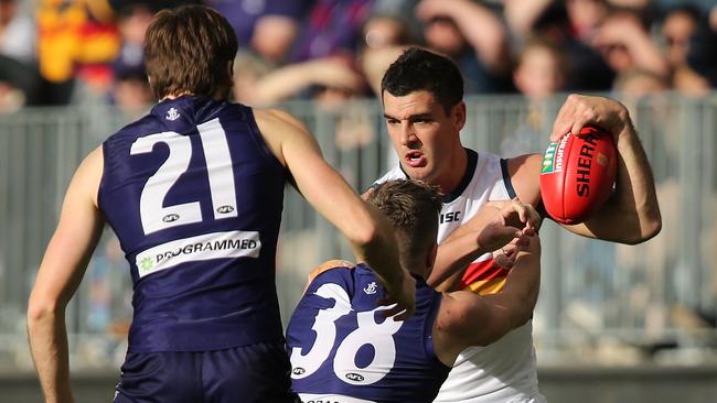 Taylor Walker of the Crows gets tackled by Luke Ryan of the Dockers on Sunday. Picture: Paul Kane/Getty Images