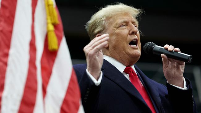 Former president Donald Trump speaks to voters during a visit to a caucus site in Clive, Iowa. Picture: Kevin Dietsch