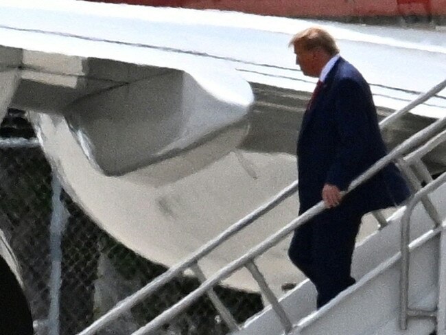 Former US President Donald Trump disembarks "Trump Force One" at Miami International Airport in Miami, Florida, on June 12, 2023. Trump is expected to appear in court in Miami on June 13 for an arraignment regarding 37 federal charges, including violations of the Espionage Act, making false statements, and conspiracy regarding his mishandling of classified material after leaving office. (Photo by CHANDAN KHANNA / AFP)