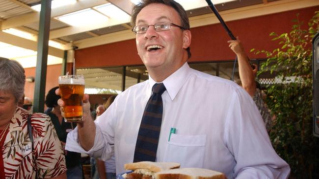 Mark Latham drinking a beer.