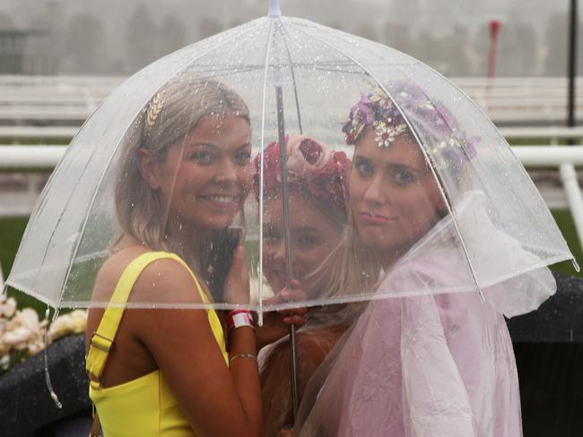 Umbrellas are a girl’s best accessory today. Picture: AAP Image/Dave Crosling