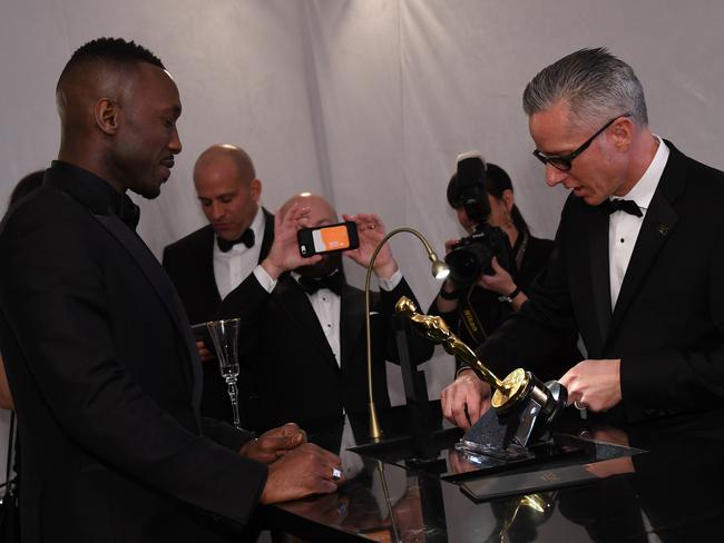 Best Supporting Actor winner, Moonlight’s Mahershala Ali gets his Oscar engraved at the Governors Ball party. Picture: AFP/Angela Weiss