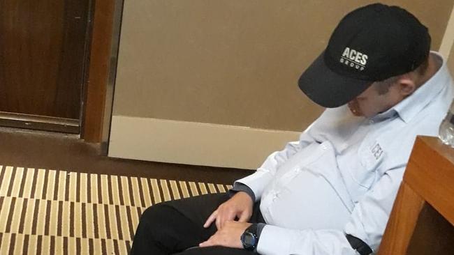 A private security guard seemingly asleep on the job at a Sydney hotel.