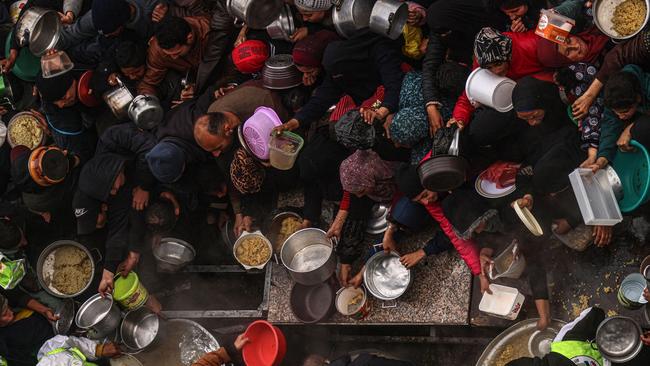 Palestinians getting donated food this month in the city of Rafah in southern Gaza. SAID KHATIB/AGENCE FRANCE-PRESSE/GETTY IMAGES