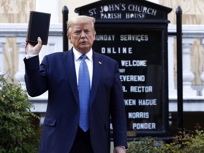 President Donald Trump holds a Bible as he visits outside St John's Church. Picture: AP