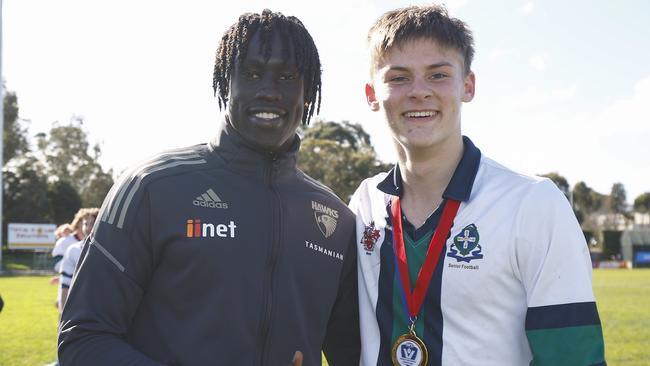 Ned Renfree of St Patrick's College poses for a photograph with AFL player Changkuoth Jiath of the Hawks after being awarded best on ground the Herald Sun Shield Intermediate Boys Grand Final. Picture: Daniel Pockett/AFL Photos/via Getty Images