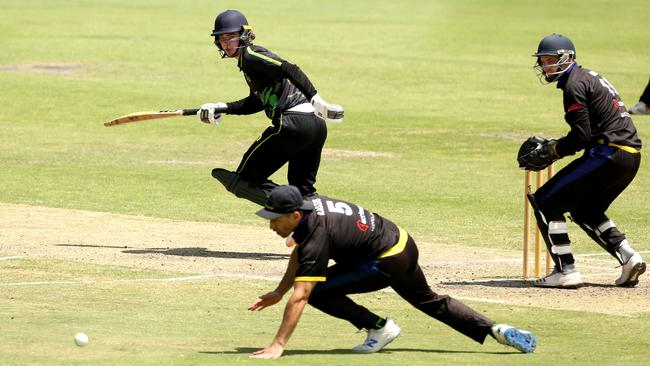 VSDCA: Box Hill’s Ben Horsnaill slides the ball past Tristan Kassis. Picture: Stuart Milligan