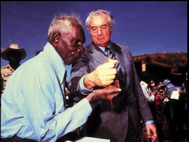 Former PM Gough Whitlam (R) pours sand into hand of Vincent Lingiari (/1920-/1997) during 1975 ceremony marking handover of traditional Gurindji land at Wave Hill. / Aboriginal profile land rights