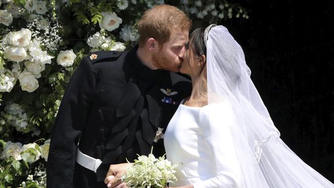 The crowd cheered as the royal couple kissed outside. (Andrew Matthews/pool photo via AP)