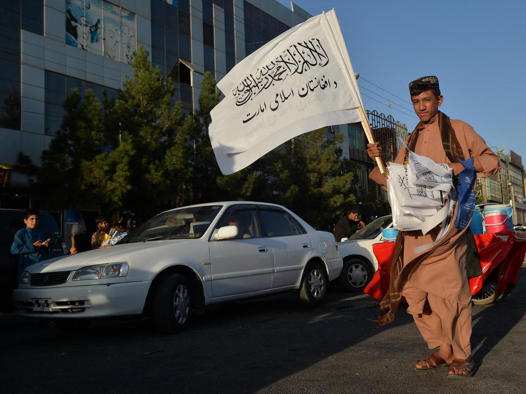 A boy selling Taliban flags looks for customers along a road in Herat. Picture: Hoshang Hashimi/AFP