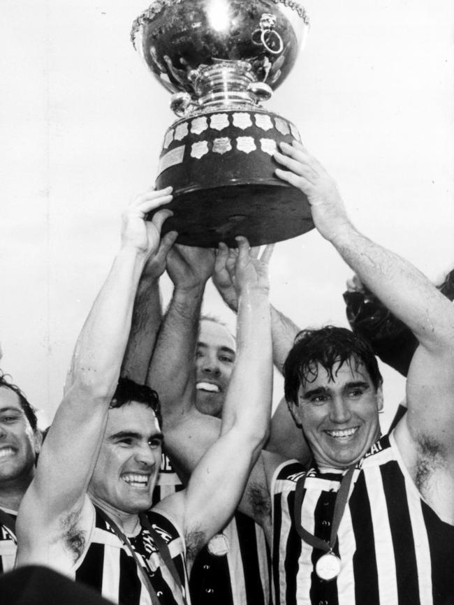 Former Port Adelaide stars Tim Ginever and Greg Phillips hold the SANFL premiership cup aloft in 1992.