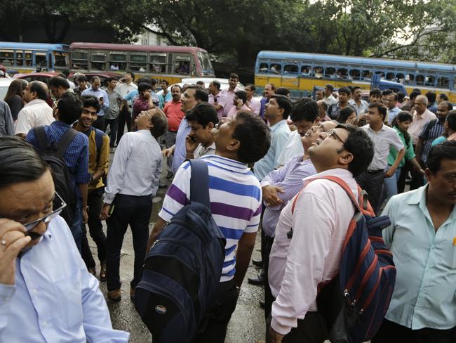 Office workers rush into the streets of Kolkata, India following tremors caused by a powerful earthquake in Myanmar. Picture: AP Photo/Bikas Das