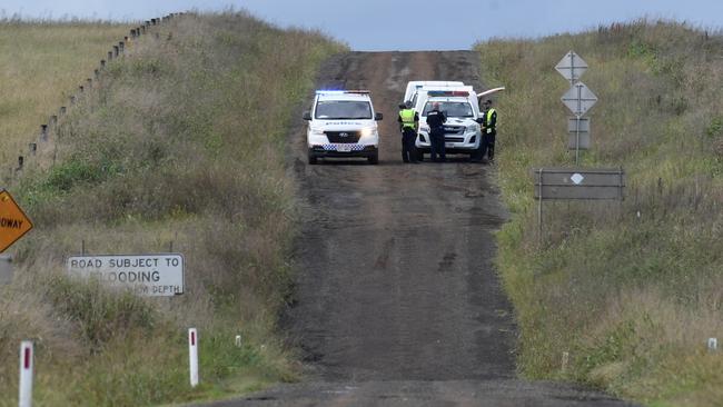 Police officers cordon off Brimblecombe Rd in Kingsthorpe, near where a man and multiple dogs were killed in floodwaters early on Monday morning.