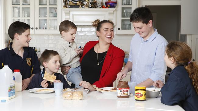 French au pair Wendy Neuville Salerian, 22, oversees breakfast with (from left) Bailey, 11, Charlie, 7, Harry, 4, Cooper, 12, and Indiana, 9.