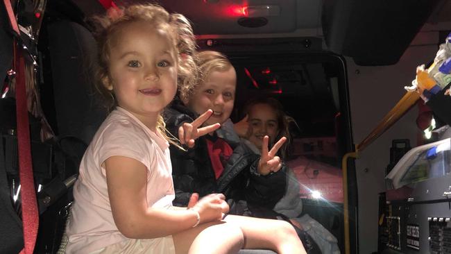 Scout, 4, Shay, 8, and Stevie, 9, in a firetruck after part of their Aspendale house caught fire. Shay has been praised for his quick thinking. Picture: Supplied