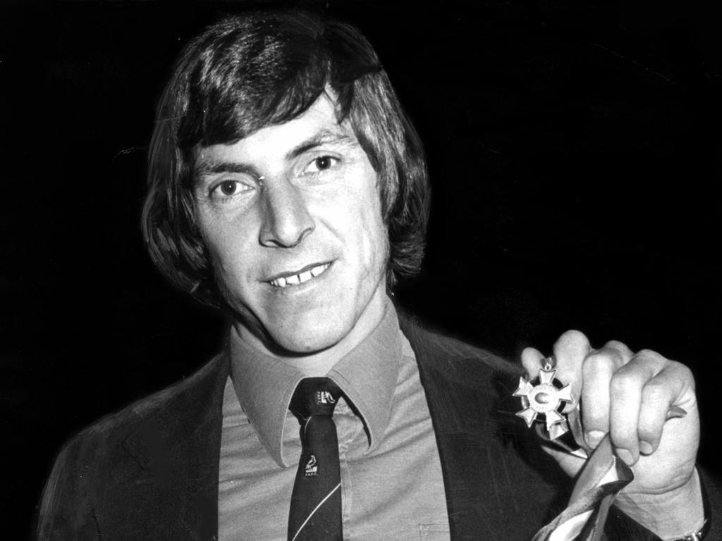 Footballer Russell Ebert holds his Magarey Medal in 1977.