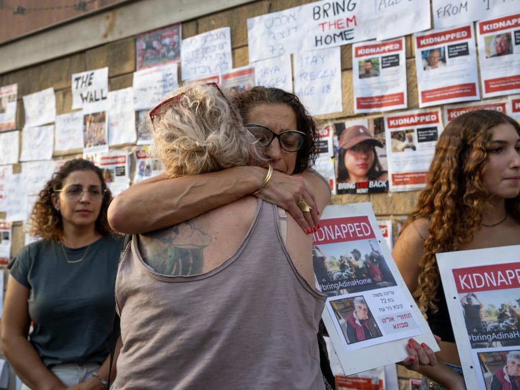 Ms Moshebarda with the sign with Adina’s picture that was taken as she was abducted. Picture: Getty