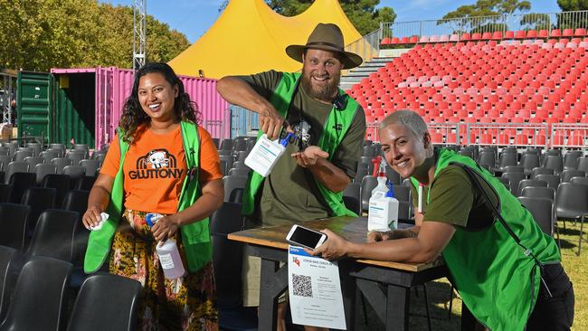 Gluttony Covid Marshals Roshni Hurdowar quartermaster, Rowan Edwards event manager and Kat Waterman site foreperson in an open are stage area with Covid measures including hand sanitiser, cleaning products, QR codes, checkerboard seating and separate entrances and exits. Picture: Tom Huntley