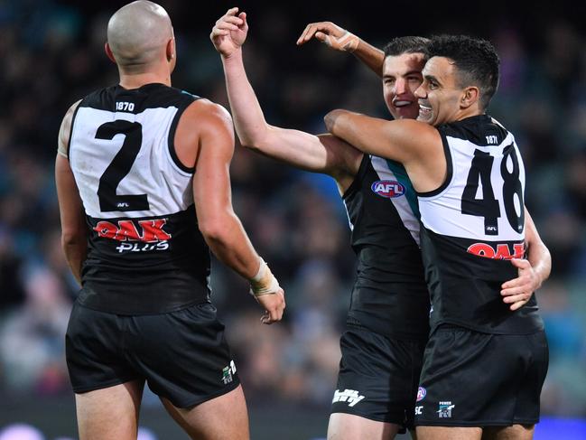 Port Power players react after scoring during the Round 13 AFL match between the Port Adelaide Power and the Western Bulldogs at Adelaide Oval in Adelaide, Thursday, June 14, 2018. (AAP Image/David Mariuz) NO ARCHIVING, EDITORIAL USE ONLY