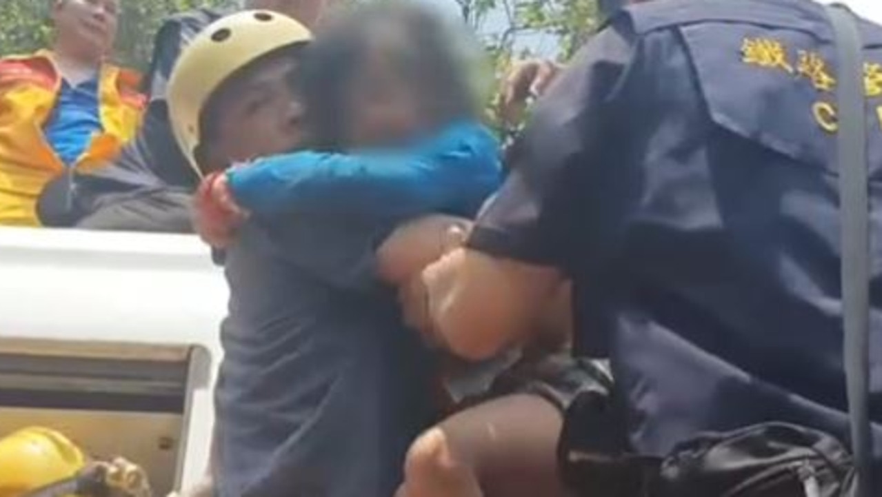 A man carries a young girl to safety. Picture: NHKWorldJapan